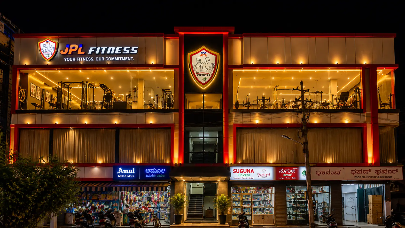 JPL Fitness illuminated facade at night