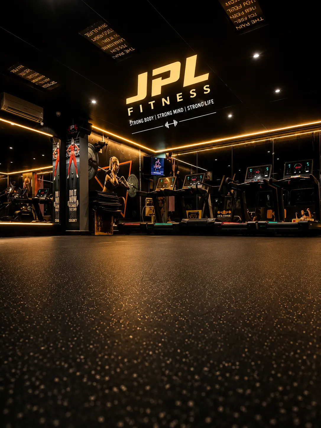 Cardio floor beneath the JPL Fitness signage wall